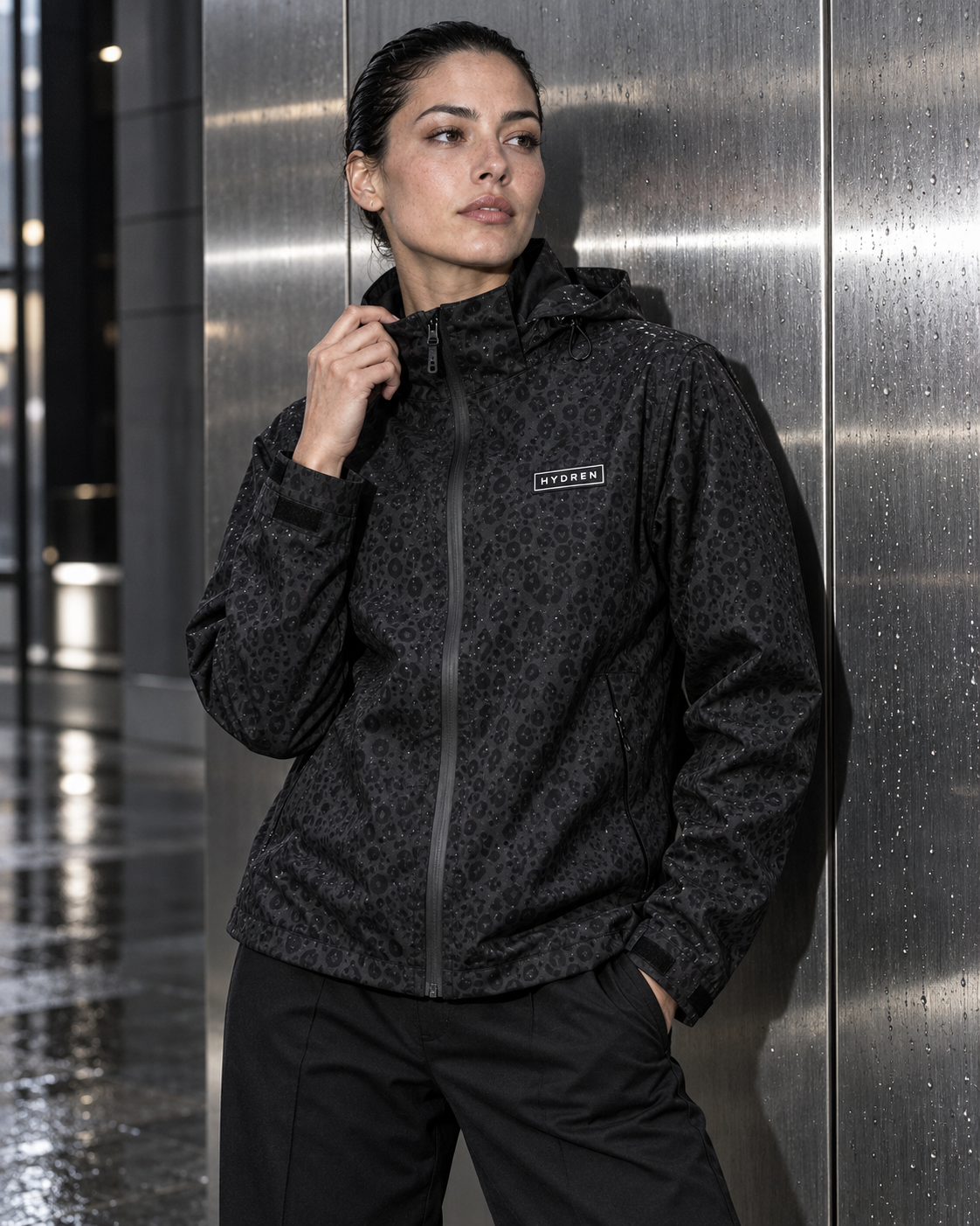 Hydren black cheetah jacket styled against a silver city wall